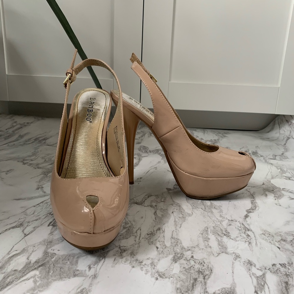 Beige patent peep toe sling back platform pumps.